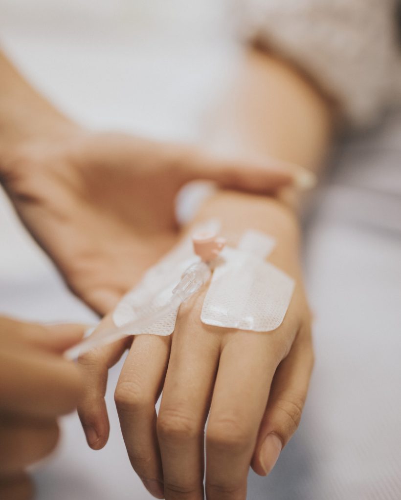 Nurse applying an IV drip to a patient